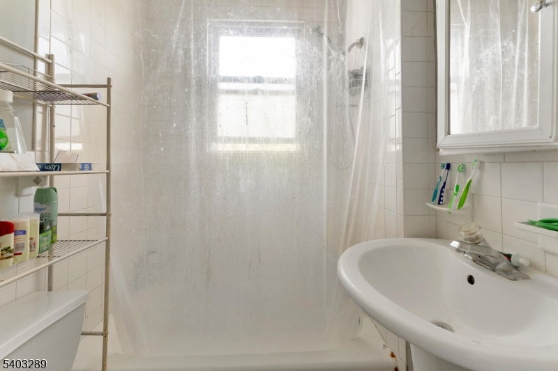 49 Caldwell Place, Unit 5 Springfield, NJ 07081 - Photo 5 of 41 a bathroom with a tub and a sink