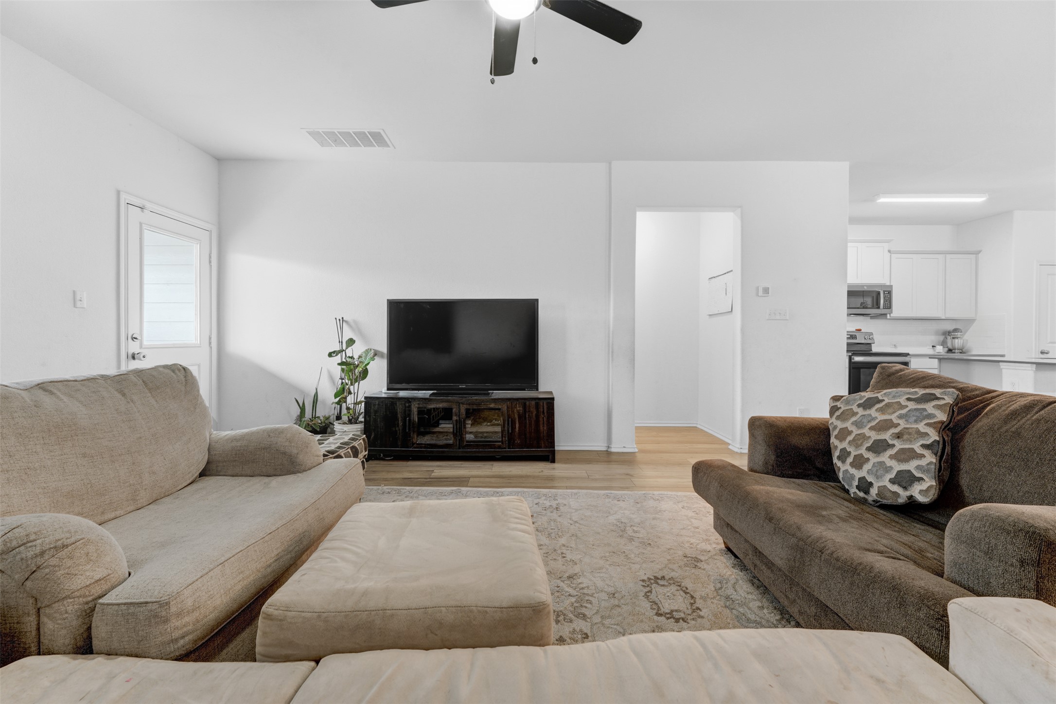 413 Perfect World Loop Jarrell, TX 76537 - Photo 39 of 39 Relax in this comfortable living room featuring hardwood flooring and an inviting open floorplan.