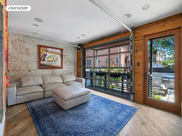 a living room with furniture and a floor to ceiling window