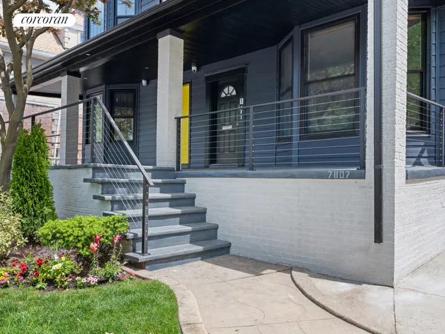 a view of house with wooden stairs and potted plants