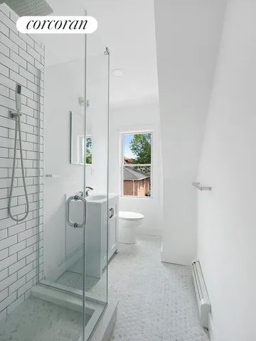 a bathroom with a shower a toilet and sink