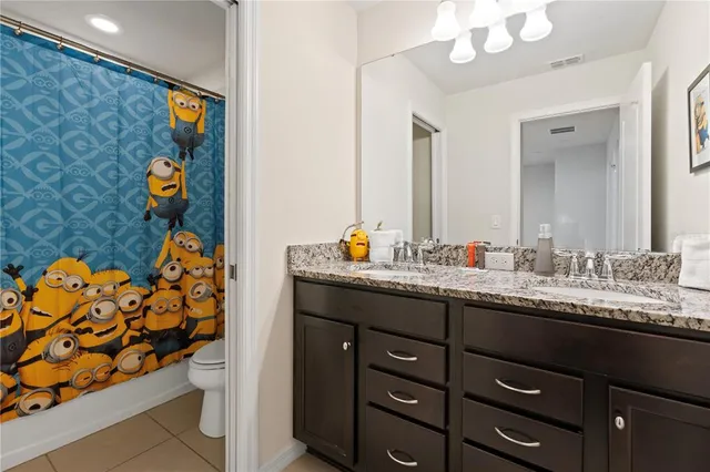 a bathroom with a sink mirror and vanity