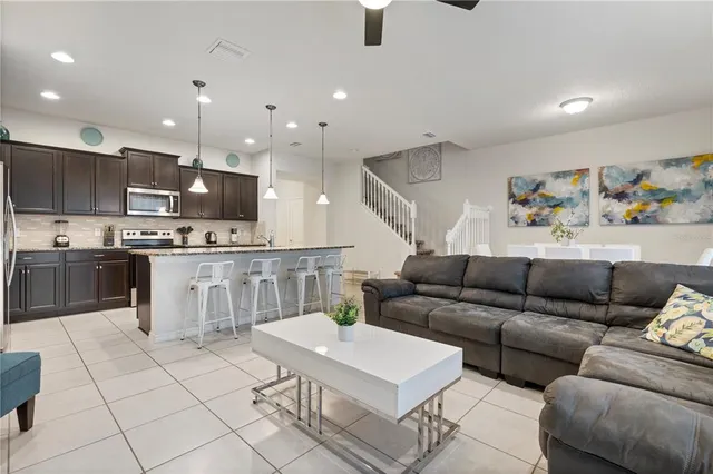a living room with furniture and kitchen view