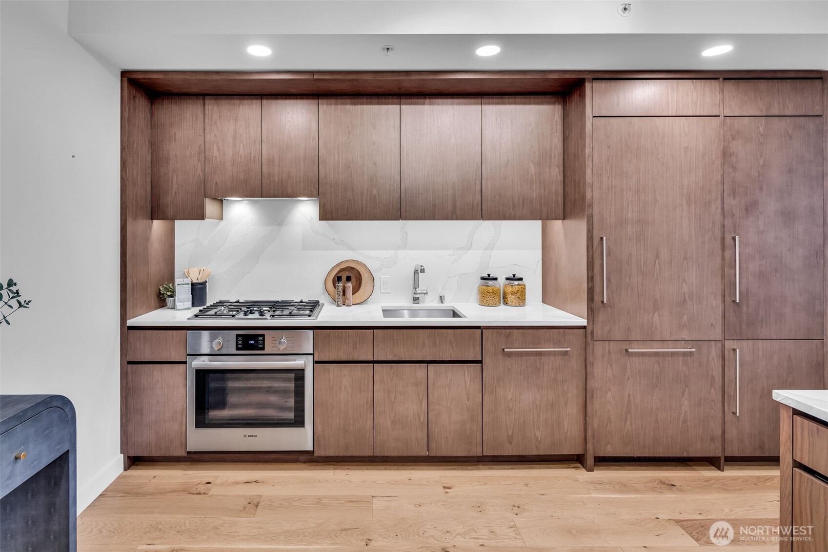 121 Stewart Street, Unit 1003 Seattle, WA 98101 - Photo 11 of 40 a kitchen with a stove and cabinets