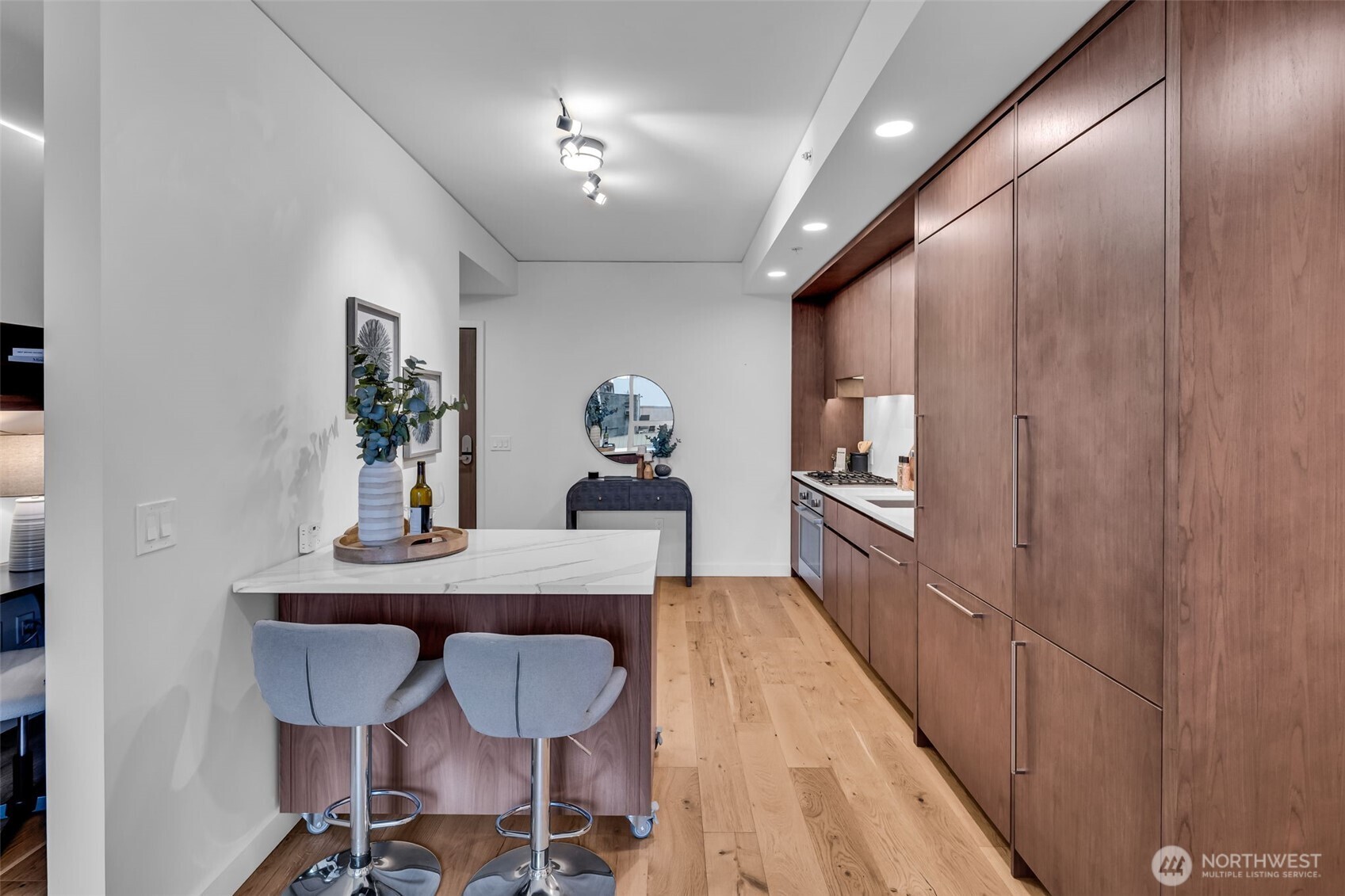 121 Stewart Street, Unit 1003 Seattle, WA 98101 - Photo 15 of 40 a view of a dining room with furniture and wooden floor