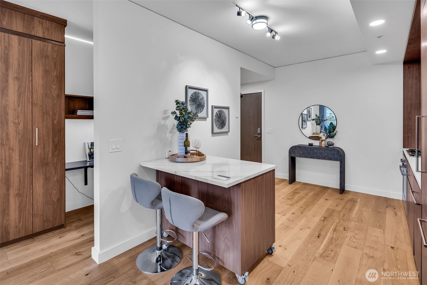 121 Stewart Street, Unit 1003 Seattle, WA 98101 - Photo 15 of 40 a view of a dining room with furniture and wooden floor