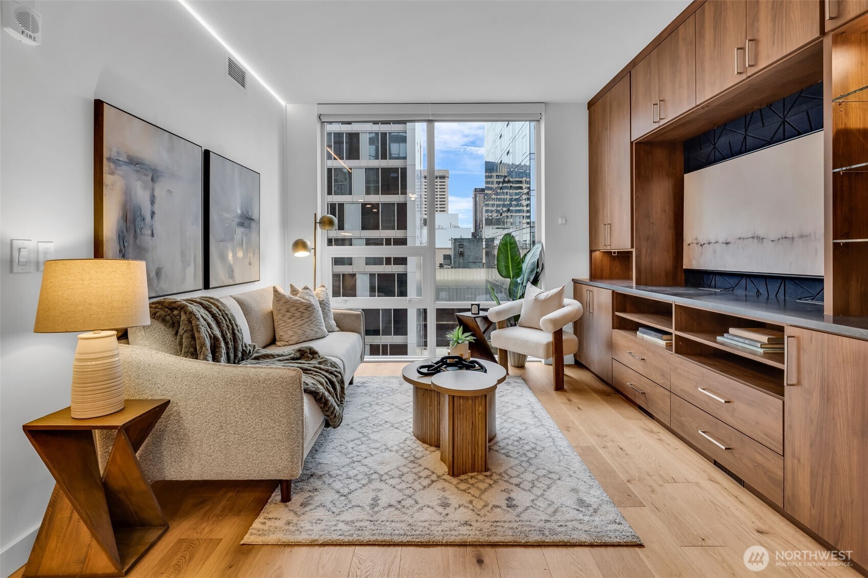 121 Stewart Street, Unit 1003 Seattle, WA 98101 - Photo 16 of 40 a living room with furniture and a flat screen tv