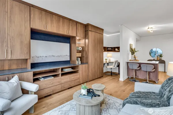 a living room with furniture and a wooden floor