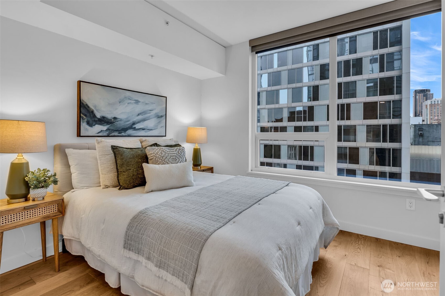 121 Stewart Street, Unit 1003 Seattle, WA 98101 - Photo 22 of 40 a bedroom with bed and a night stand
