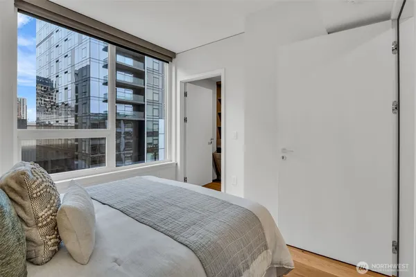 a bedroom with a bed and a large window