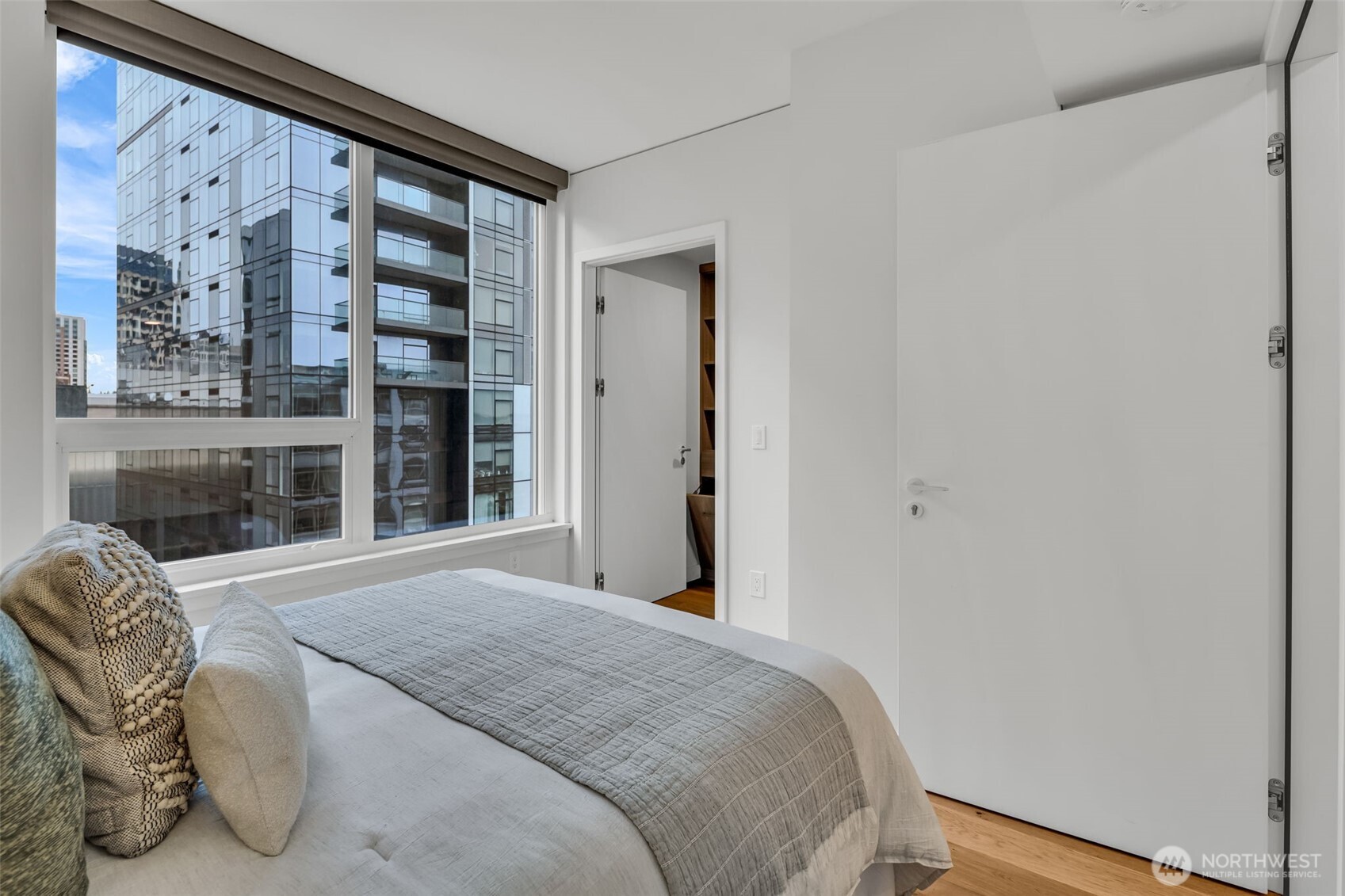 121 Stewart Street, Unit 1003 Seattle, WA 98101 - Photo 23 of 40 a bedroom with a bed and a large window