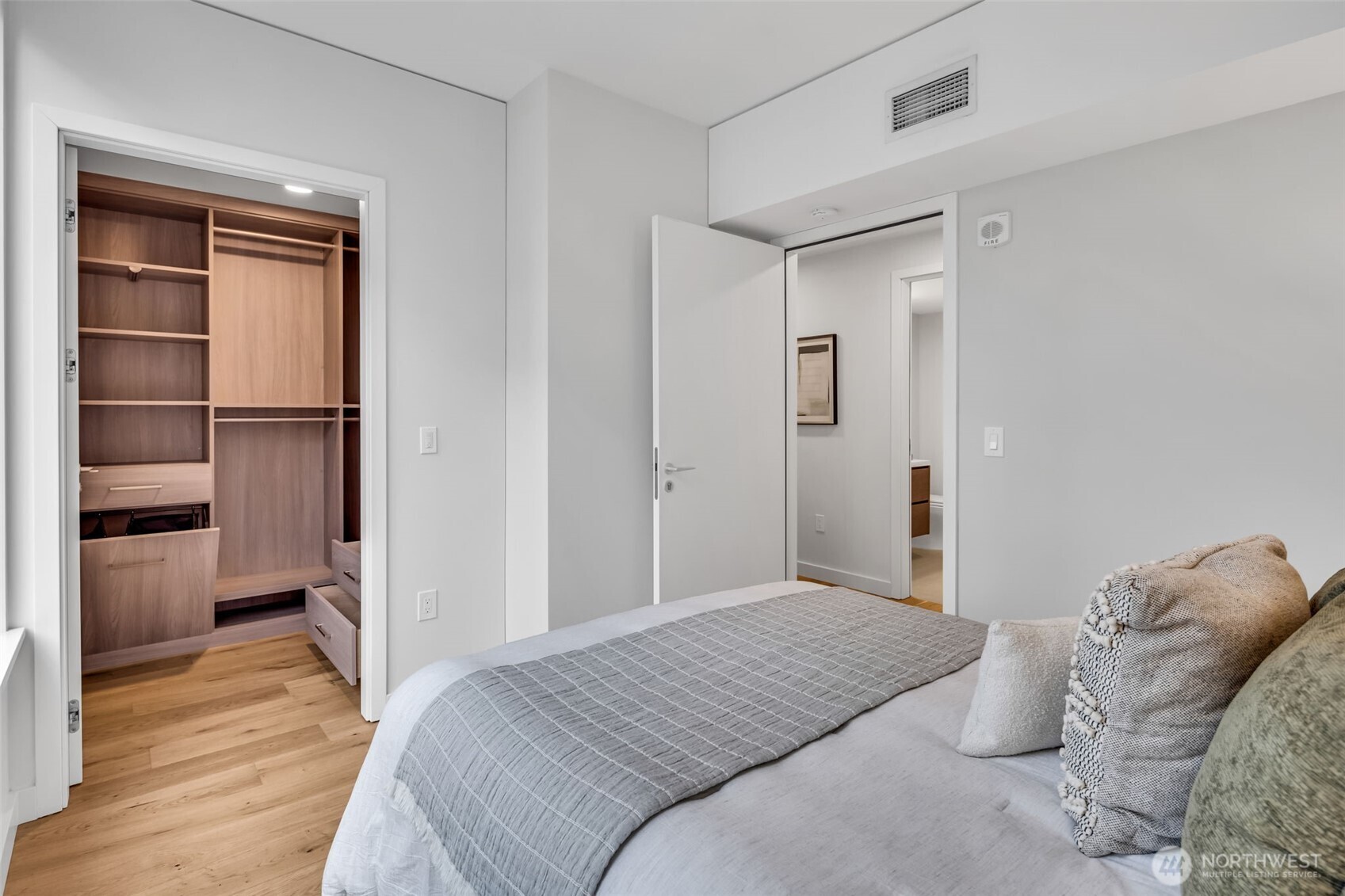 121 Stewart Street, Unit 1003 Seattle, WA 98101 - Photo 24 of 40 a bedroom with a bed and a view of bathroom