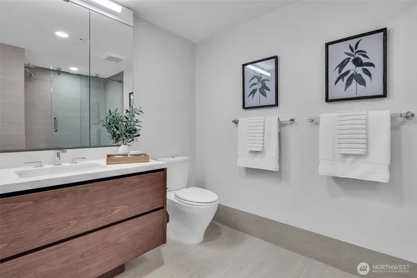 a view of bathroom with a toilet sink and mirror