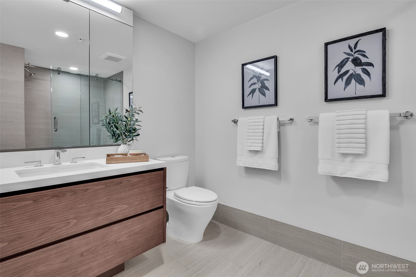 121 Stewart Street, Unit 1003 Seattle, WA 98101 - Photo 27 of 40 a view of bathroom with a toilet sink and mirror