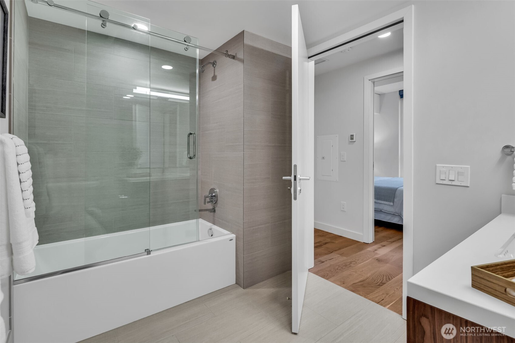 121 Stewart Street, Unit 1003 Seattle, WA 98101 - Photo 28 of 40 a bathroom with a bathtub and a shower