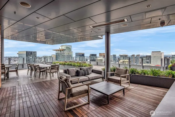 a living room with furniture a wooden floor and city view