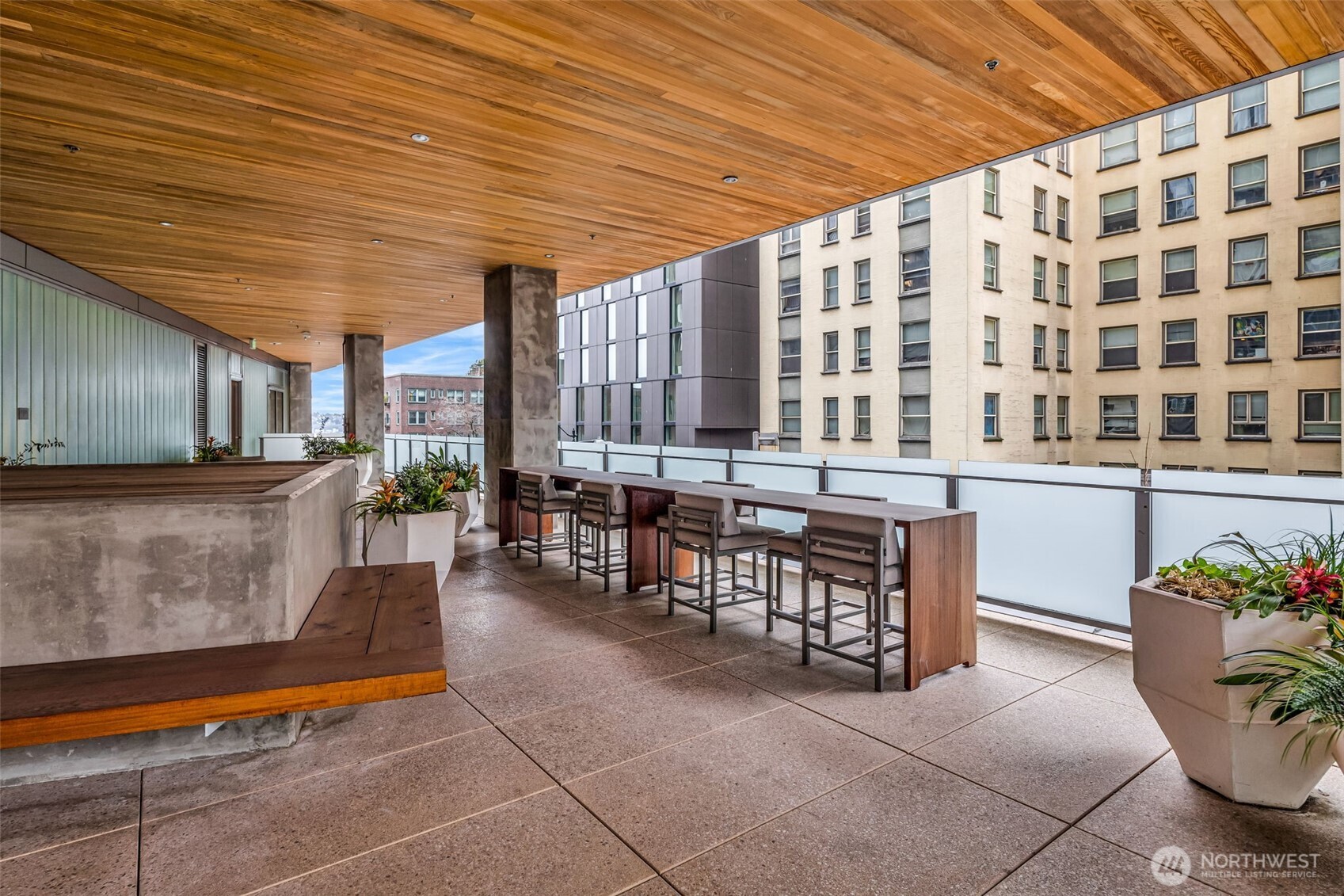 121 Stewart Street, Unit 1003 Seattle, WA 98101 - Photo 34 of 40 a living room filled with furniture and a potted plant