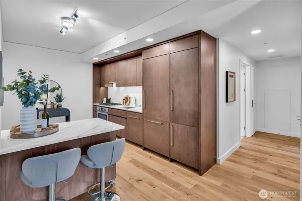 a kitchen with sink refrigerator dining table and chairs