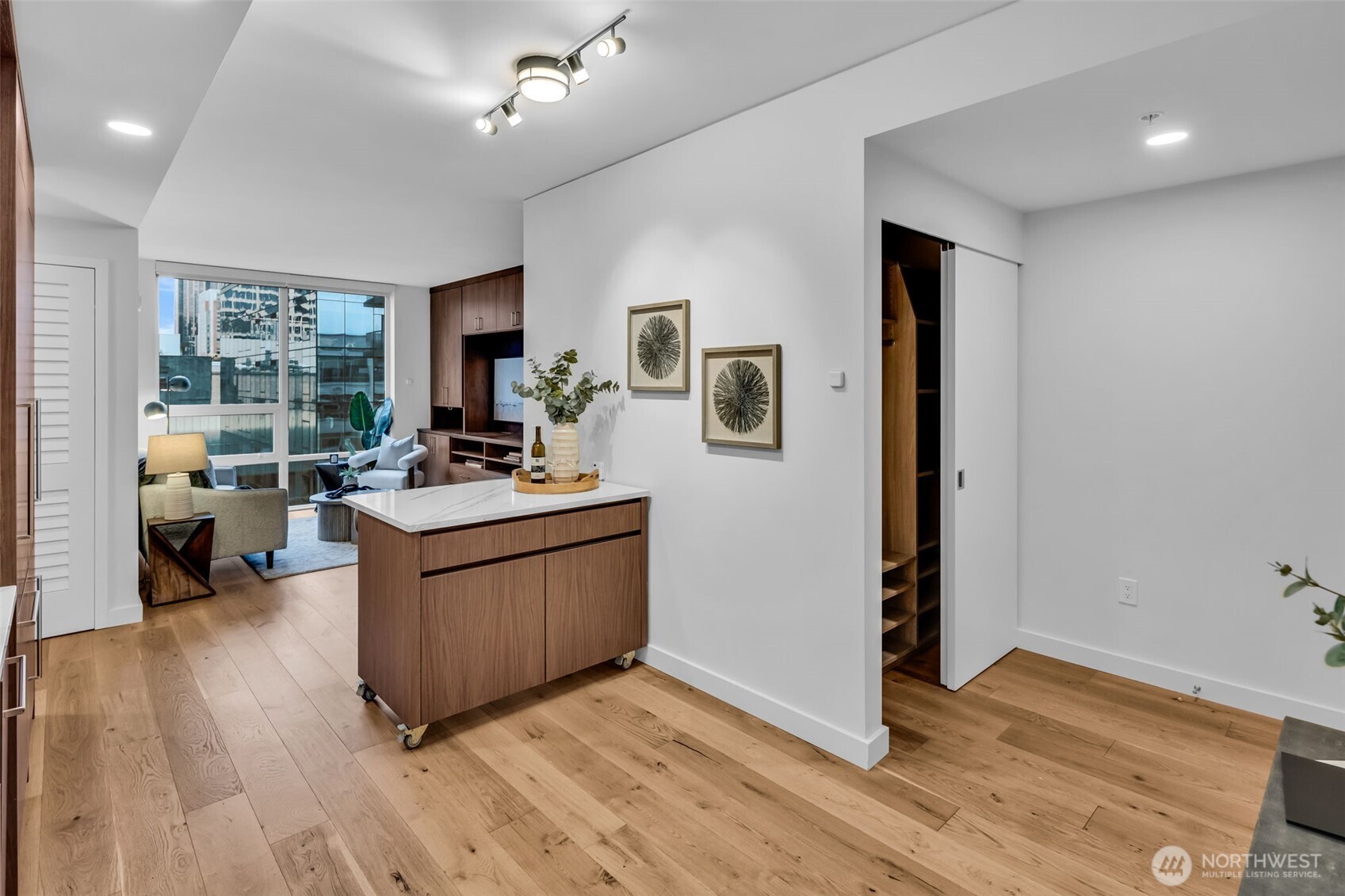 121 Stewart Street, Unit 1003 Seattle, WA 98101 - Photo 10 of 40 a living room with furniture and a wooden floor