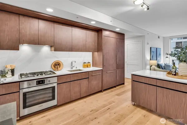 a kitchen with kitchen island granite countertop wooden cabinets and white appliances