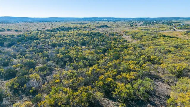 an aerial view of beach and residential houses with outdoor space