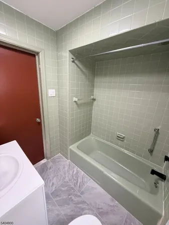 a bathroom with a bathtub and shower