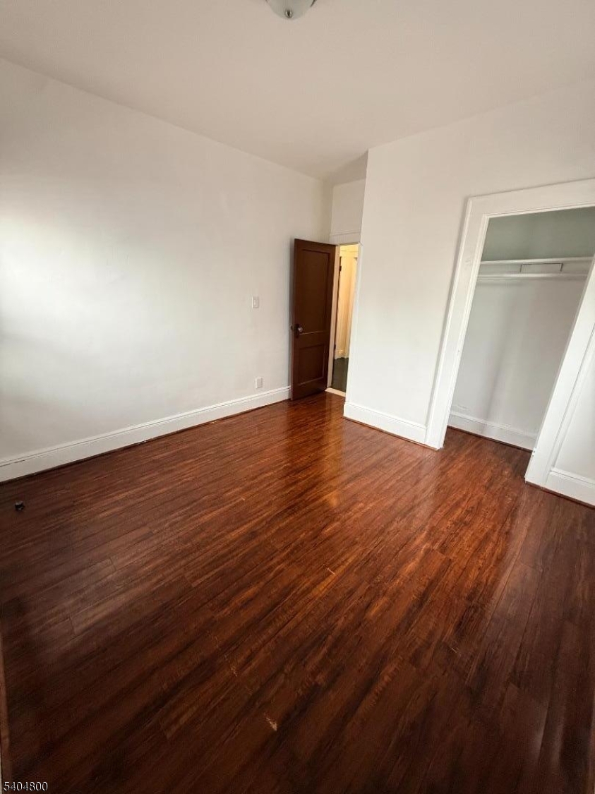 200 North 15th Street, Unit 1 Bloomfield, NJ 07003 - Photo 13 of 13 an empty room with wooden floor and closet