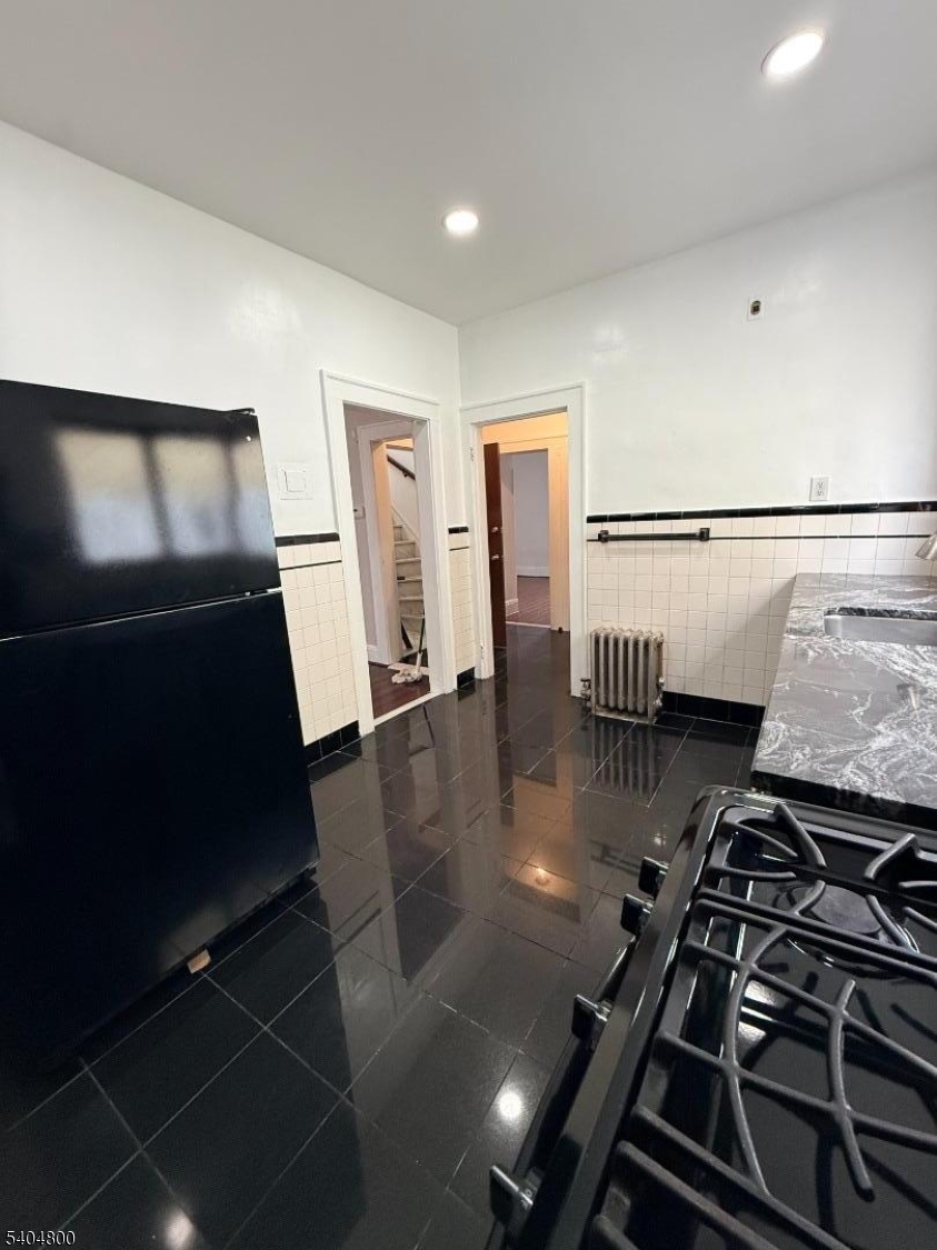 200 North 15th Street, Unit 1 Bloomfield, NJ 07003 - Photo 3 of 13 a kitchen with a stove and a refrigerator