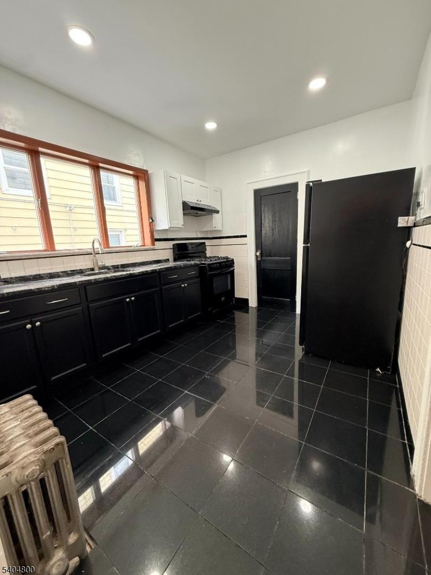 200 North 15th Street, Unit 1 Bloomfield, NJ 07003 - Photo 4 of 13 a kitchen with granite countertop stainless steel appliances a sink stove and refrigerator