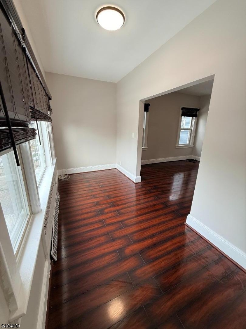 200 North 15th Street, Unit 1 Bloomfield, NJ 07003 - Photo 8 of 13 a view of an empty room with wooden floor and stairs