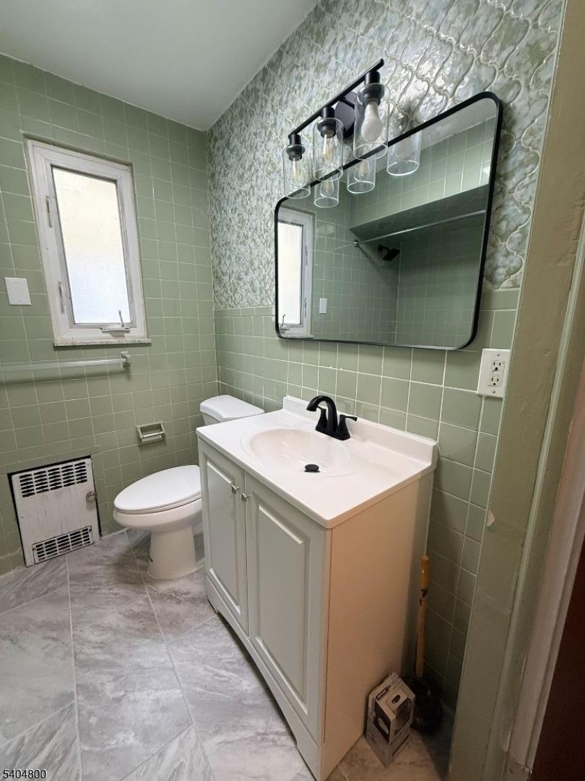 200 North 15th Street, Unit 1 Bloomfield, NJ 07003 - Photo 10 of 13 a bathroom with a toilet sink and mirror