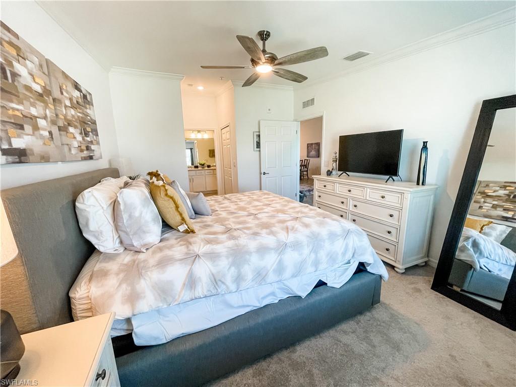 16000 Grassland Lane, Unit 3127 Babcock Ranch, FL 33982 - Photo 15 of 44 a spacious bedroom with a bed and a flat screen tv