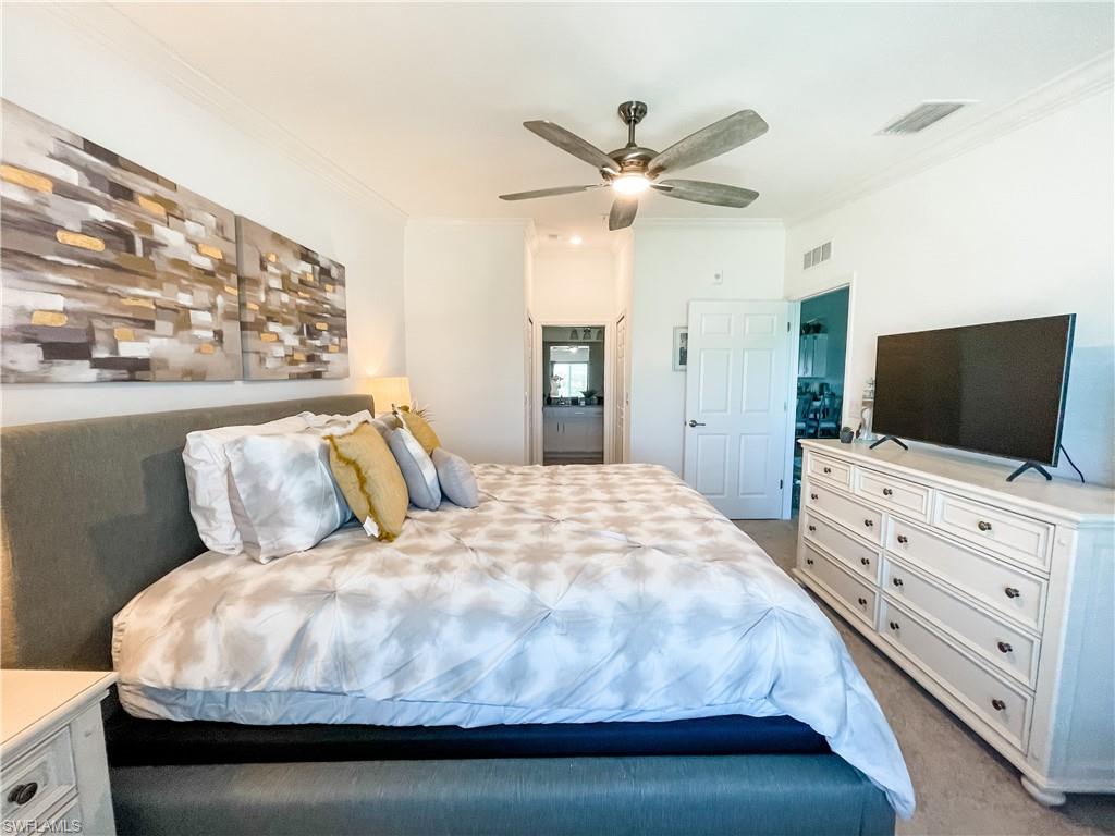 16000 Grassland Lane, Unit 3127 Babcock Ranch, FL 33982 - Photo 16 of 44 a bedroom with a large bed and flat tv screen on dresser