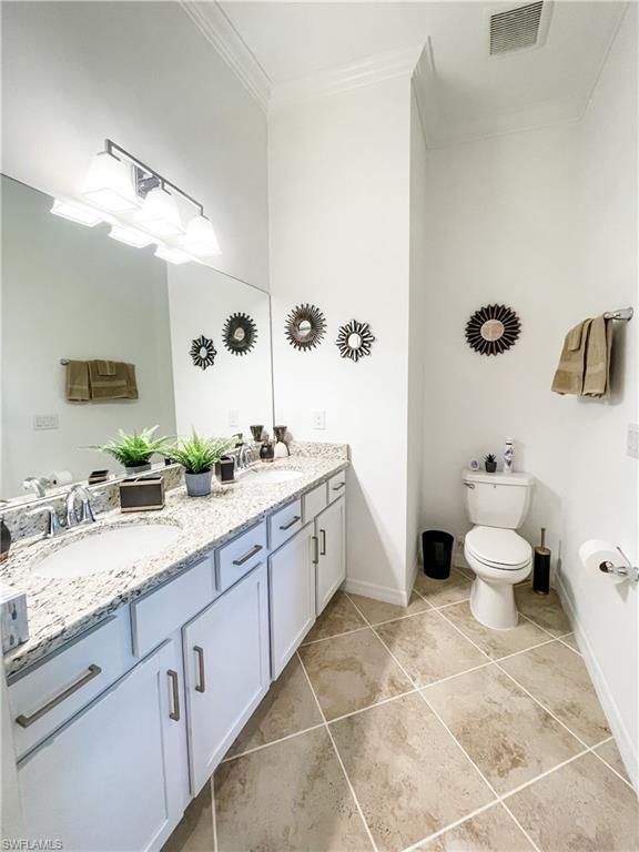 16000 Grassland Lane, Unit 3127 Babcock Ranch, FL 33982 - Photo 18 of 44 a spacious bathroom with a granite countertop toilet sink and mirror