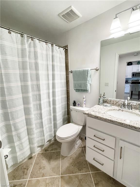 16000 Grassland Lane, Unit 3127 Babcock Ranch, FL 33982 - Photo 20 of 44 a bathroom with a granite countertop sink toilet and shower