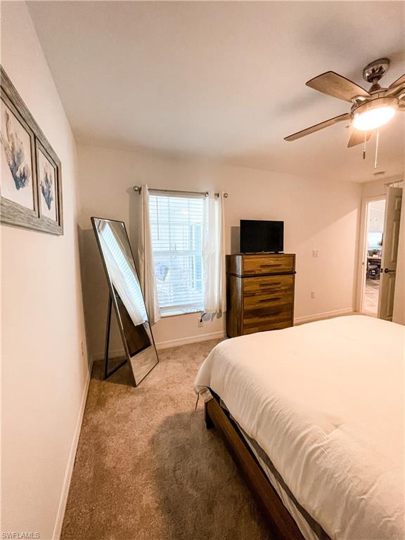 16000 Grassland Lane, Unit 3127 Babcock Ranch, FL 33982 - Photo 24 of 44 a spacious bedroom with a bed and a flat screen tv