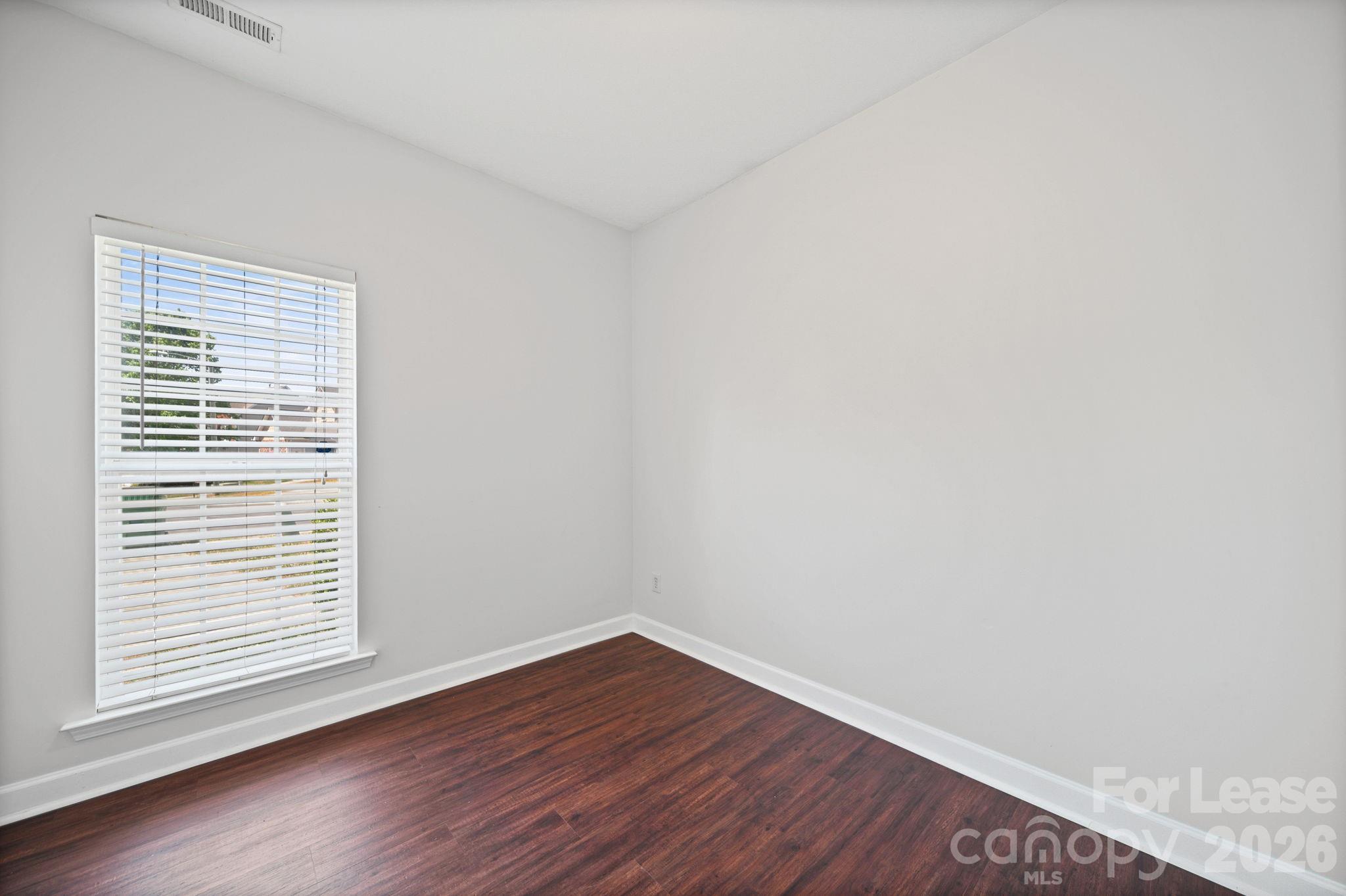 1728 Brian William Road Charlotte, NC 28212 - Photo 12 of 15 a view of an empty room with wooden floor and a window