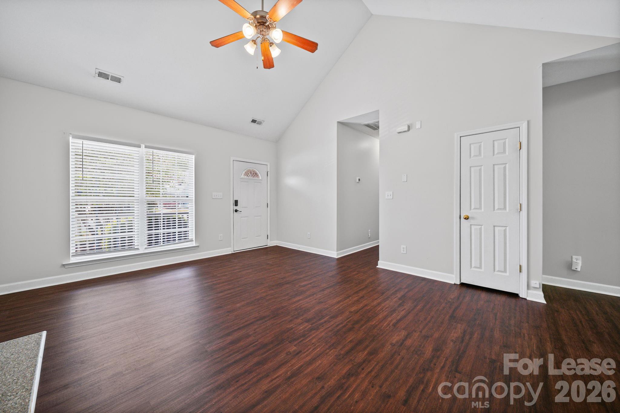 1728 Brian William Road Charlotte, NC 28212 - Photo 3 of 15 a view of an empty room with wooden floor and a window