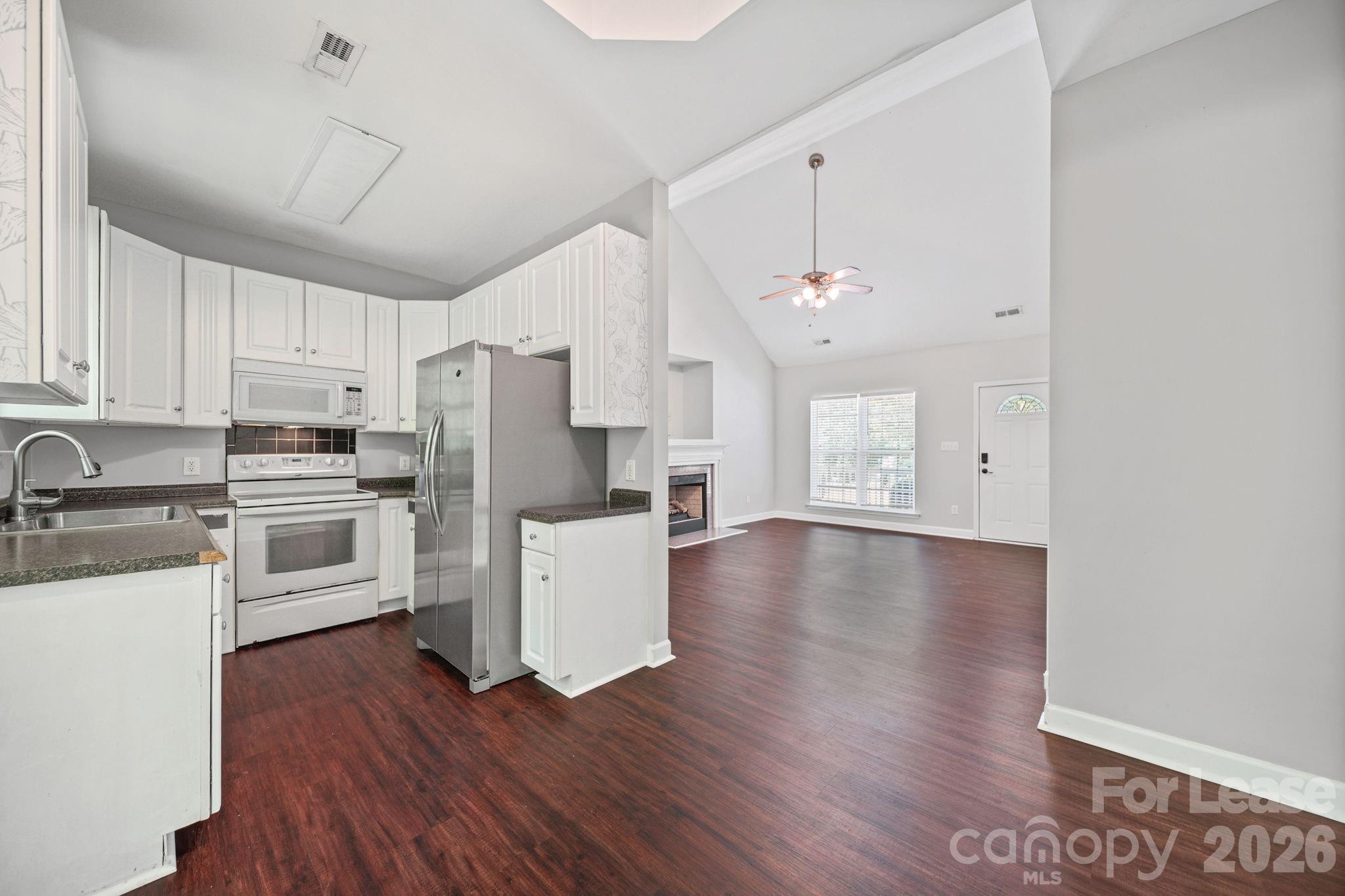 1728 Brian William Road Charlotte, NC 28212 - Photo 4 of 15 a kitchen with white cabinets and stainless steel appliances