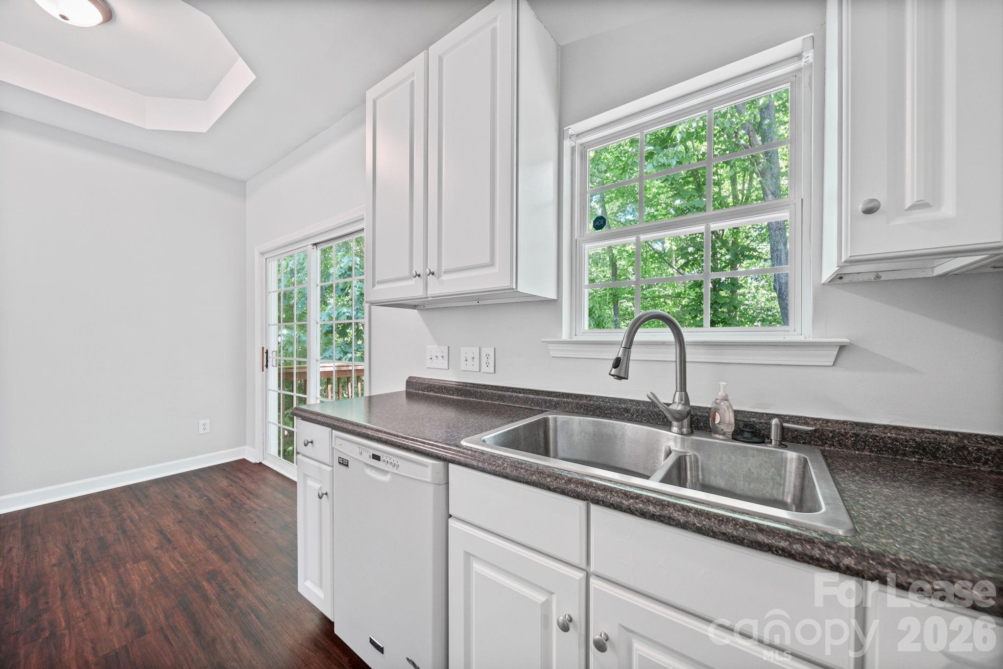 1728 Brian William Road Charlotte, NC 28212 - Photo 6 of 15 a kitchen with sink a window and cabinets