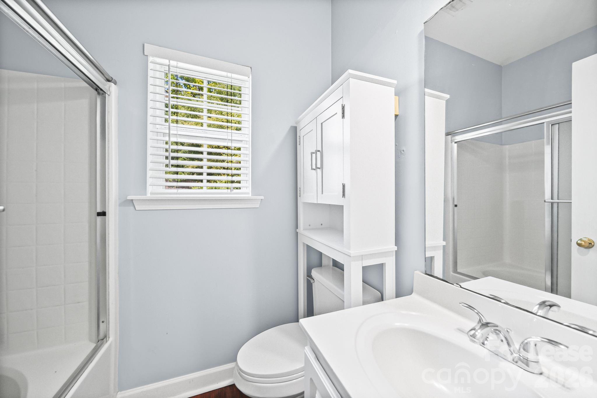 1728 Brian William Road Charlotte, NC 28212 - Photo 9 of 15 a bathroom with a sink a toilet and shower