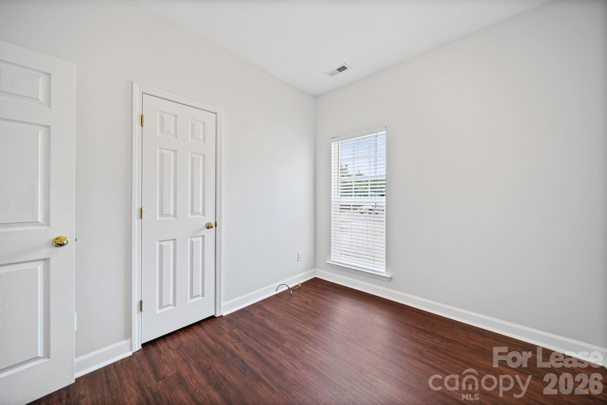 1728 Brian William Road Charlotte, NC 28212 - Photo 10 of 15 an empty room with wooden floor & windows