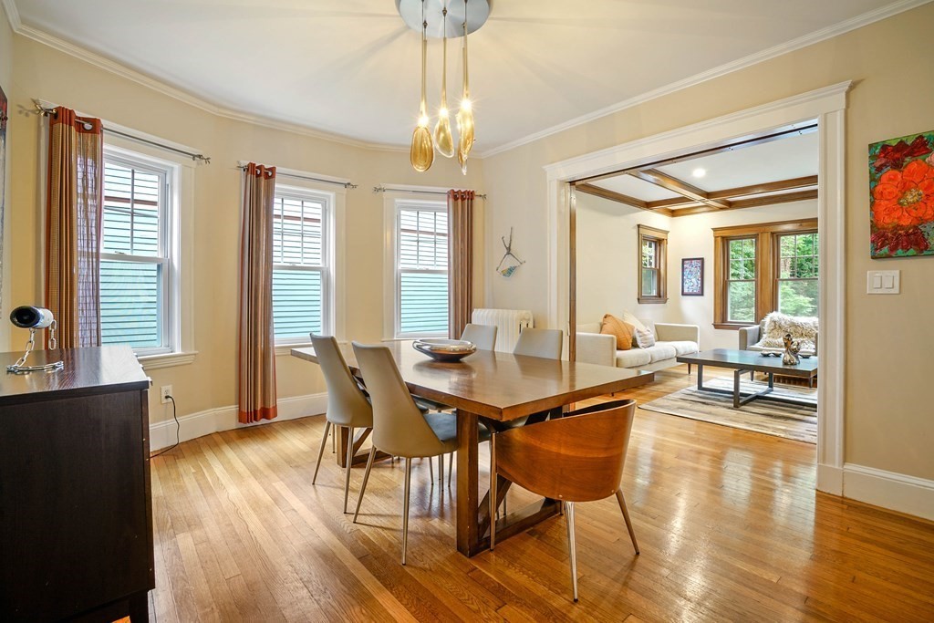 a view of a dining room with furniture and wooden floor