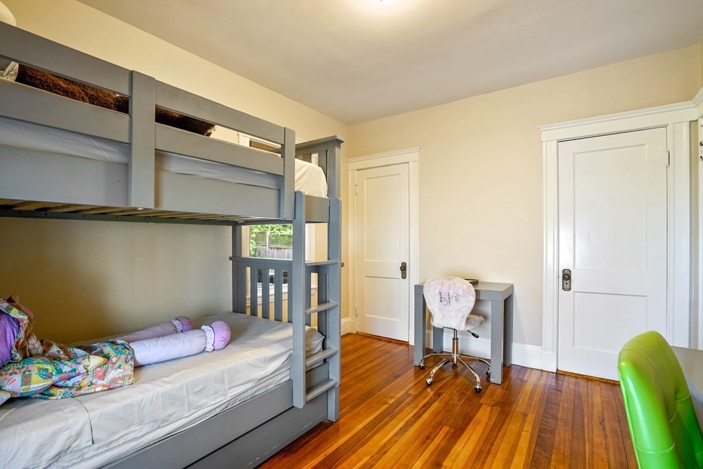 23 Stetson Street, Unit ONE Brookline, MA 02446 - Photo 10 of 15 a bedroom with furniture and a wooden floor