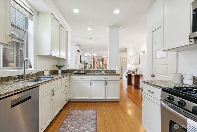 a kitchen with a sink stove and cabinets