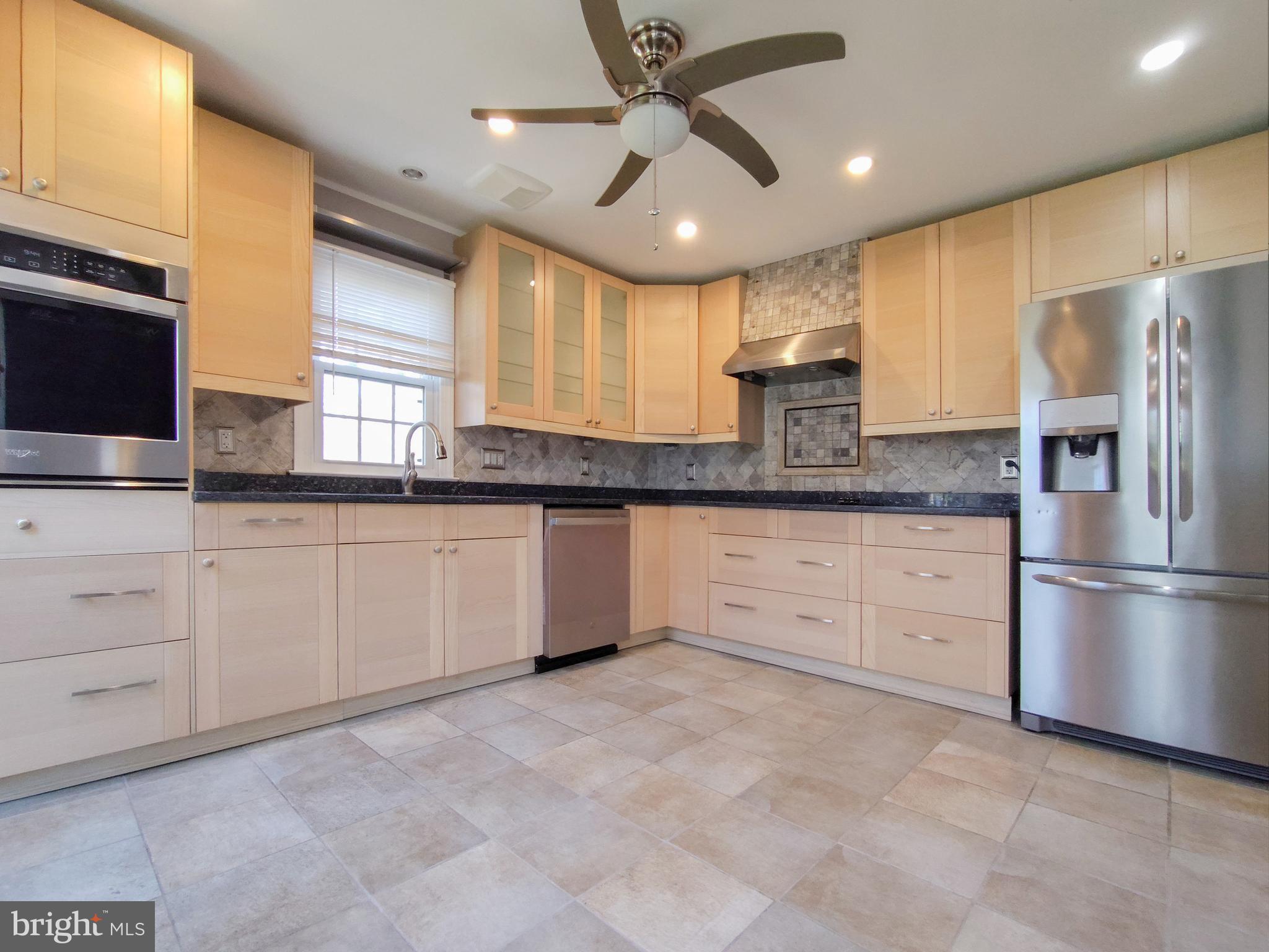 9513 Cherry Oak Court Burke, VA 22015 - Photo 11 of 40 a kitchen with granite countertop a sink stainless steel appliances and window