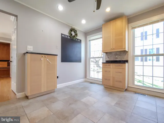 an empty room with windows and closet