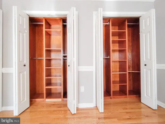 a view of a livingroom with wooden floor and a window