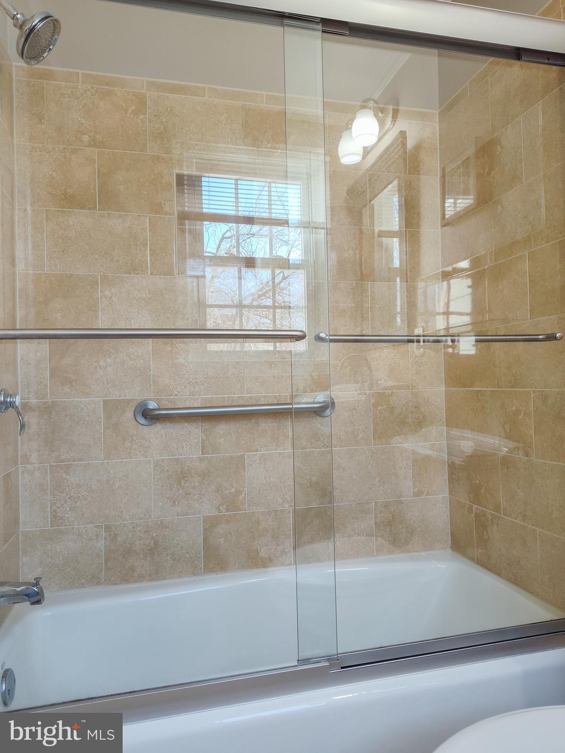 9513 Cherry Oak Court Burke, VA 22015 - Photo 19 of 40 a bathroom with a bathtub and a shower