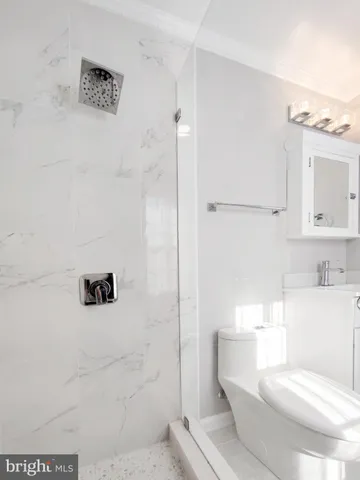 a bathroom with a toilet and a shower